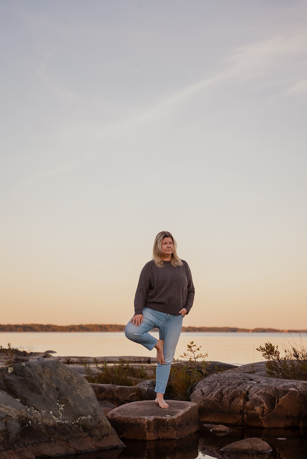 porträttfoto posandes på ett ben vid vattnet
